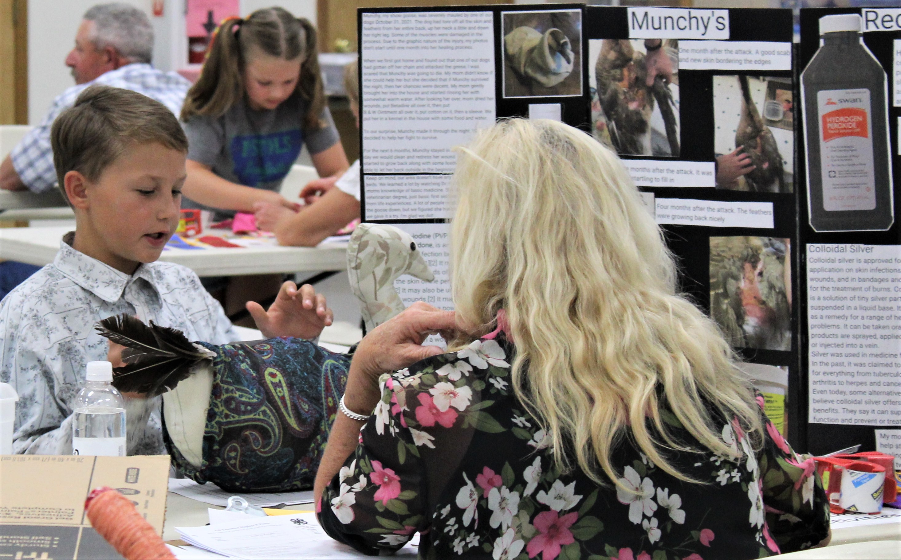 Animal Project judge listens to a Lake County 4-H member tell about his project.